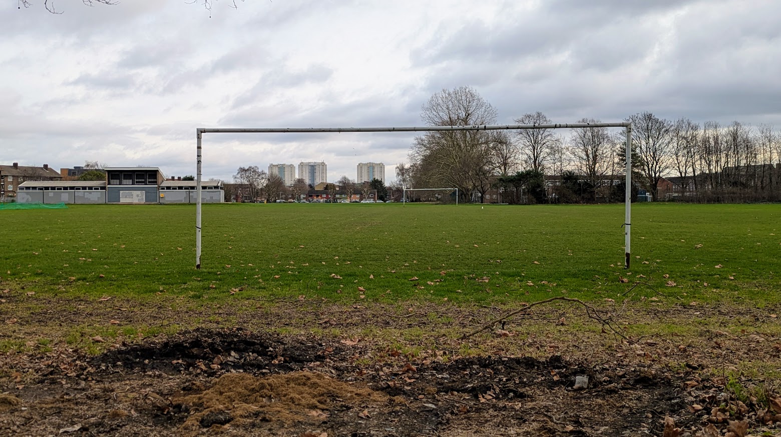 Church Street Recreation Ground in Edmonton, showing a grass sports pitch with football goals, trees and housing in the background.